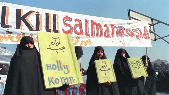 In this file photo taken on February 17, 1989, Iranian women are seen holding banners which read "Holly Koran" and "Kill Salman Rushdie" during a demonstration against British writer Salman Rushdie in Tehran.(AFP)