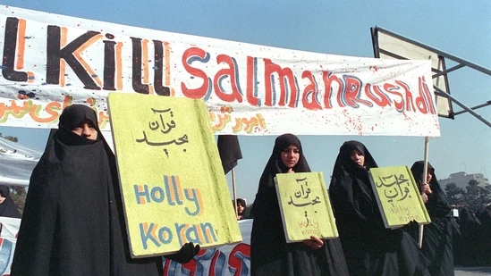 In this file photo taken on February 17, 1989, Iranian women are seen holding banners which read &quot;Holly Koran&quot; and &quot;Kill Salman Rushdie&quot; during a demonstration against British writer Salman Rushdie in Tehran.(AFP)